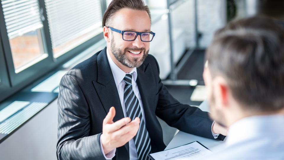 A consultant sitting opposite a man