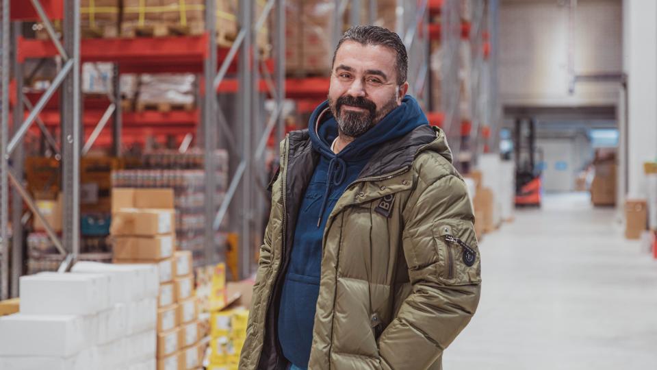 Canan Karadag, founder of the Karadag supermarkets, is standing in a storehouse